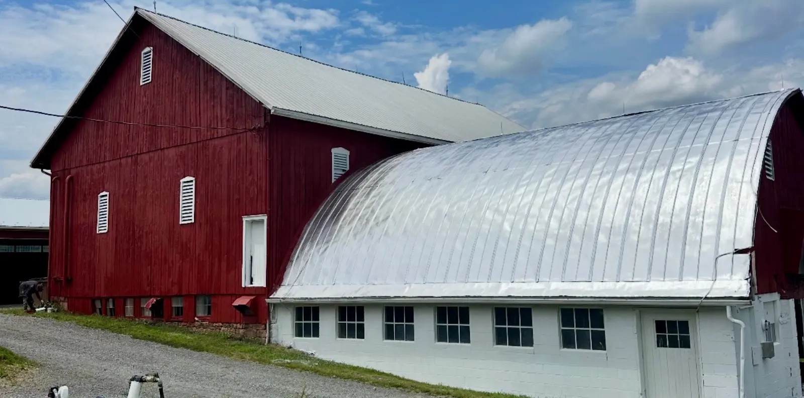Agricultural bank barn arched metal roof restored with aluminum roof coating