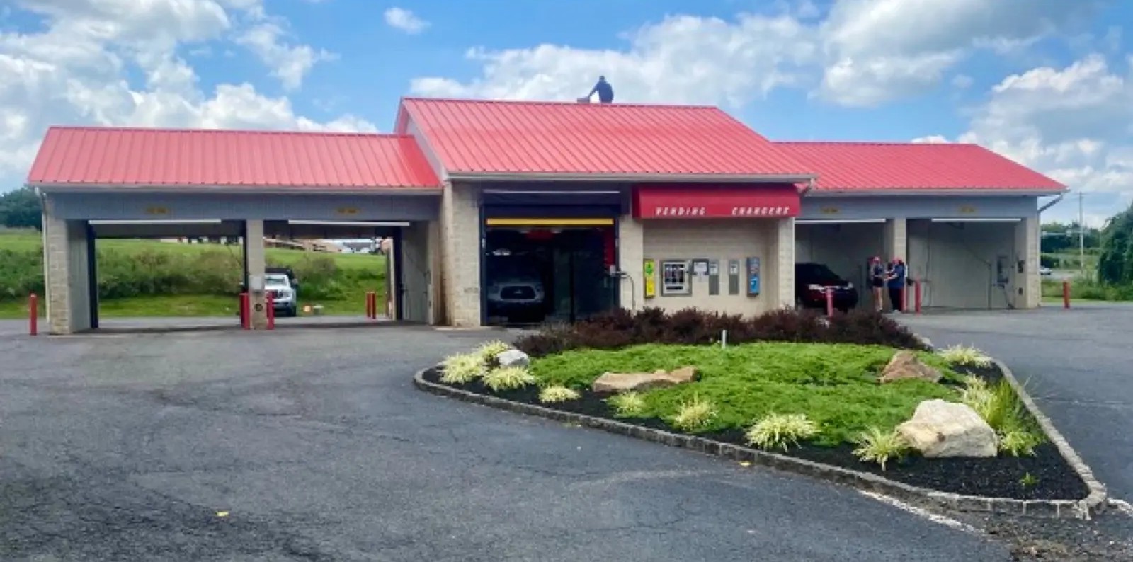 Commercial car wash metal roof coated in red protective finish
