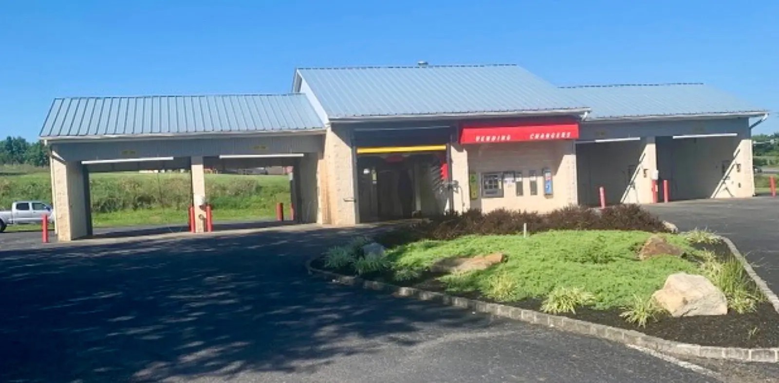 Before — Commercial car wash metal roof coated in red protective finish