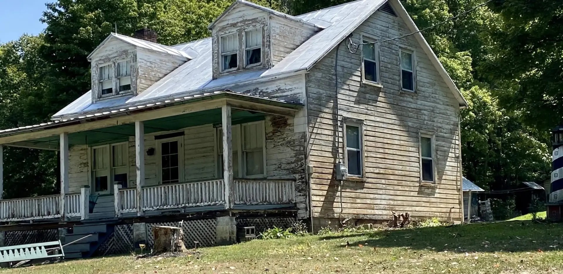 Before — Peeling historic farmhouse restored with full exterior repaint