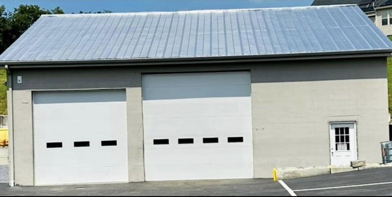 Rusted commercial garage roof recoated and building repainted
