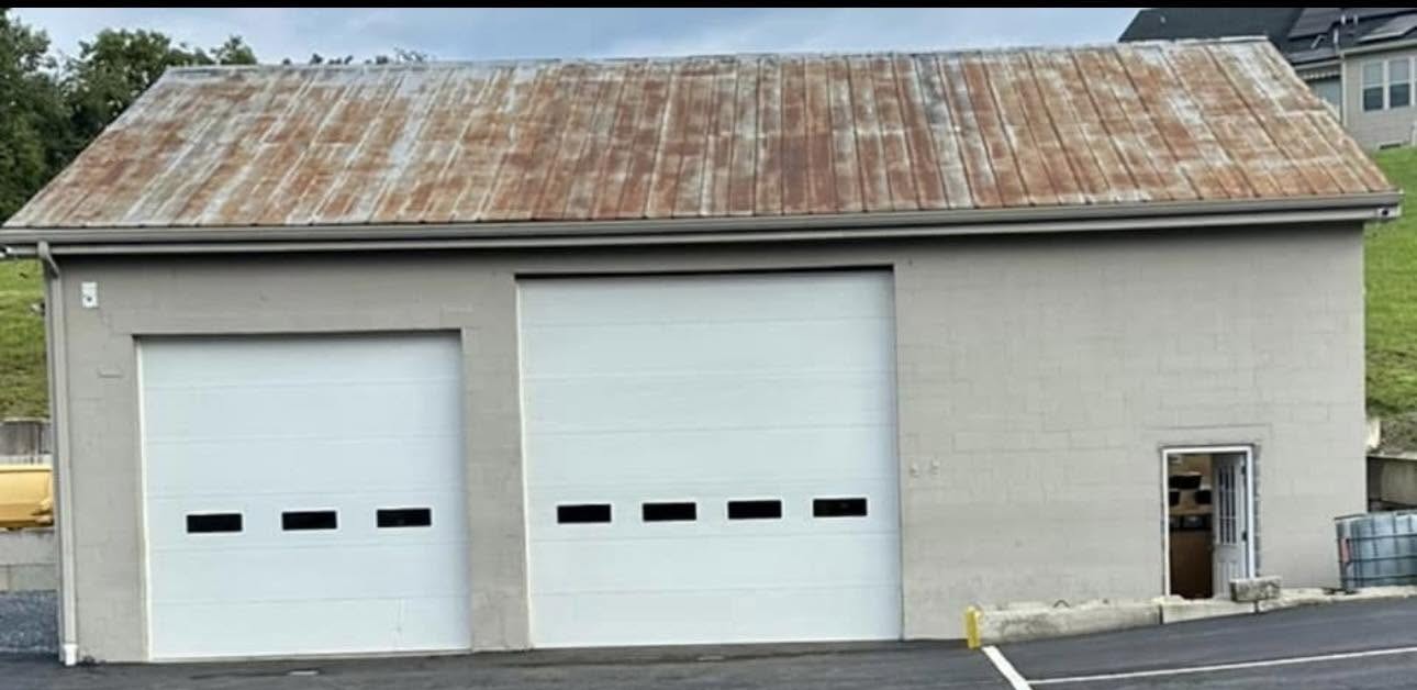 Before — Rusted commercial garage roof recoated and building repainted